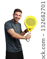Man enjoying a fun moment with a bright yellow paddle during a sports activity 132682701
