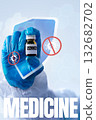 Hand holding vaccine vial with protective shield symbol against viruses in a medical setting 132682702