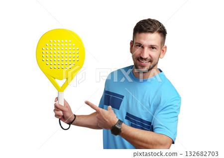 Man smiles and points at a bright yellow paddle in a studio setting Man smiles and points at a bright yellow paddle in a studio setting 132682703