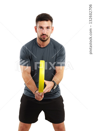 Man practicing with a yellow fitness circle in a bright indoor space Man practicing with a yellow fitness circle in a bright indoor space 132682706