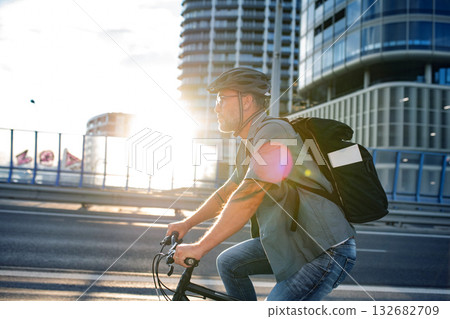Male cyclist riding bike down the street. Male cyclist riding bike down the street. 132682709