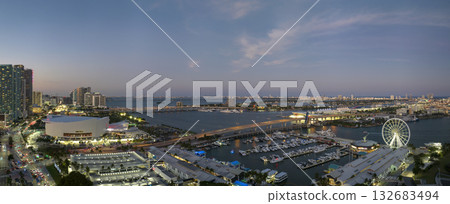 High illuminated skyscrapers of Brickell, city's financial center. Skyviews Miami Observation Wheel at Bayside Marketplace with reflections in Biscayne Bay water and US urban landscape at night High illuminated skyscrapers of Brickell, city's financial center. Skyviews Miami Observation Wheel at Bayside Marketplace with reflections in Biscayne Bay water and US urban landscape at night 132683494