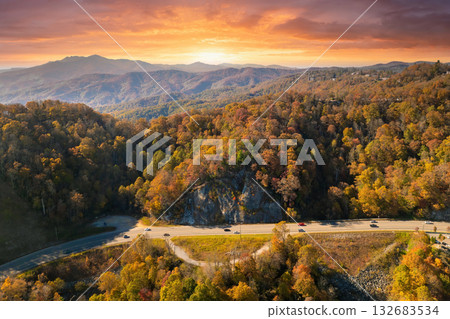 Freeway road with fast moving traffic cars and trucks in North Carolina Appalachian mountains in fall season. Interstate transportation infrastructure in USA 132683534