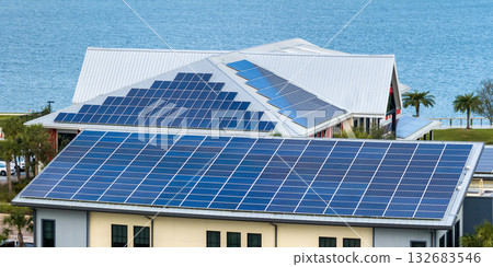 Florida office building with solar roof. Blue photovoltaic panels for producing clean ecological electric energy. Investing in renewable electricity concept 132683546