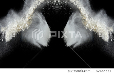 Clouds of white flour or powder scattering against a black background Clouds of white flour or powder scattering against a black background 132683555