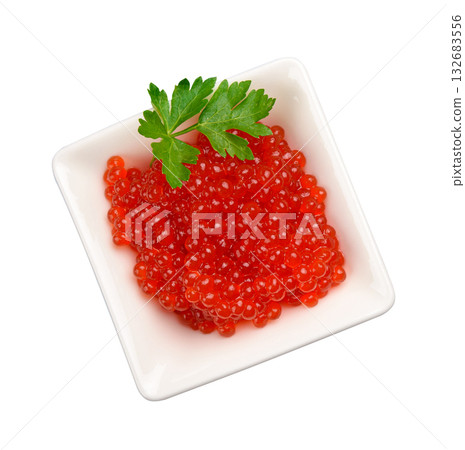 Red caviar in a white square ceramic bowl decorated with a sprig of parsley Red caviar in a white square ceramic bowl decorated with a sprig of parsley 132683556