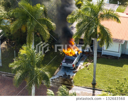 Firefighters extinguishing burning car on residential street in Punta Gorda in Florida 132683568