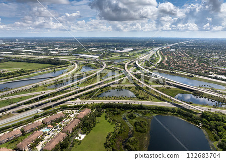 Complex highway overpass elevated direction lanes with busy traffic in Miami, Florida. American high speed road crossroads Complex highway overpass elevated direction lanes with busy traffic in Miami, Florida. American high speed road crossroads 132683704