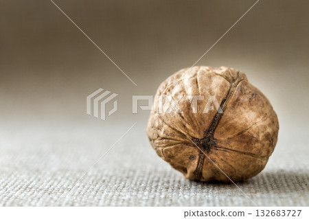 Close-up of walnut in wooden shell isolated on light copy space background. Healthy tasty organic food concept. Close-up of walnut in wooden shell isolated on light copy space background. Healthy tasty organic food concept. 132683727