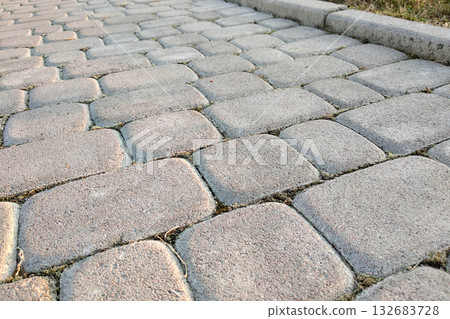 Close-up of slab stone paved path way at park or backyard. Walkway footpath road at house yard garden. Close-up of slab stone paved path way at park or backyard. Walkway footpath road at house yard garden. 132683728