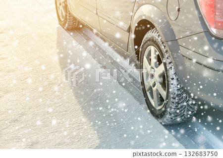 Close-up of car wheels rubber tires in deep winter snow. Transportation and safety concept. 132683750