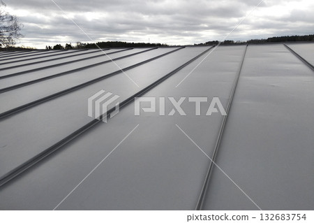 Close-up detail of house roof made from gray metal sheets. 132683754