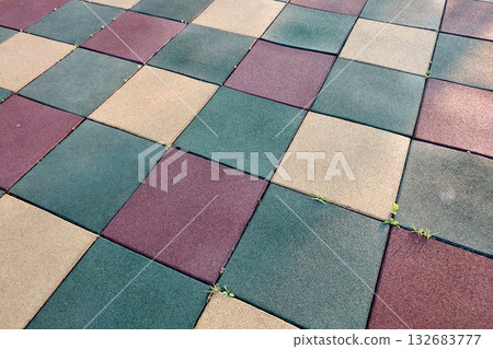 Close up of soft rubber tiles for covering at outdoor gym of stadium at preschool yard. 132683777