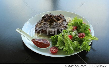 Roasted beef with greens, red sauce and pita on white plate Roasted beef with greens, red sauce and pita on white plate 132684577