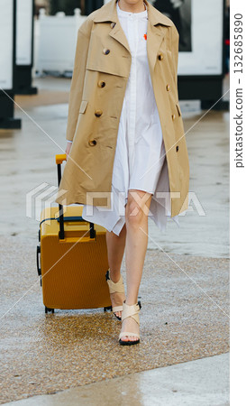 A stylish woman with a bright yellow suitcase. A stylish woman with a bright yellow suitcase. 132685890