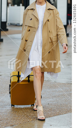 A stylish woman with a bright yellow suitcase. A stylish woman with a bright yellow suitcase. 132685891