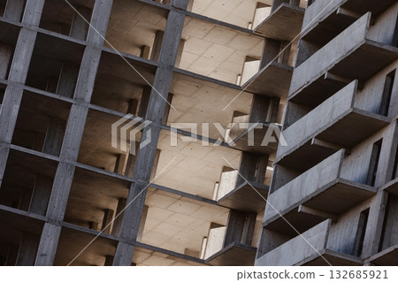 Geometric concrete structure of a building under construction. 132685921