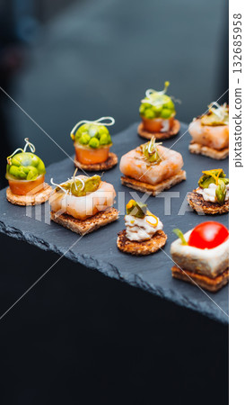 Elegant gourmet appetizers on a slate tray. 132685958