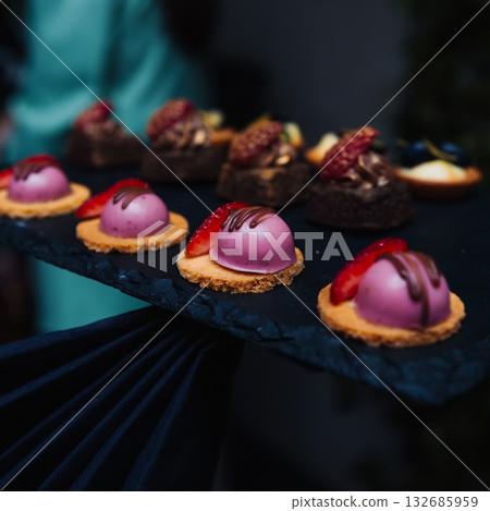 Elegant gourmet desserts on a slate tray Elegant gourmet desserts on a slate tray 132685959