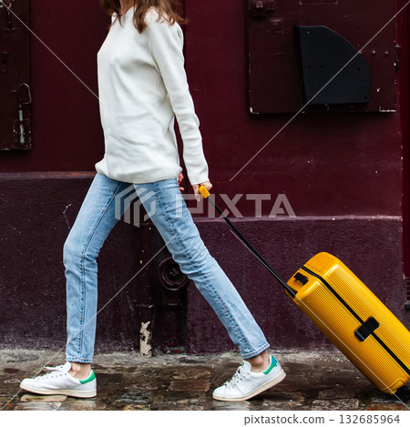 Stylish woman with a yellow suitcase. Stylish woman with a yellow suitcase. 132685964