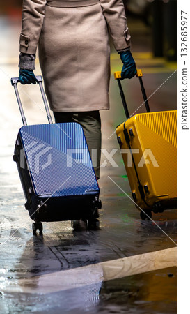 A chic traveler with two suitcases. A chic traveler with two suitcases. 132685977