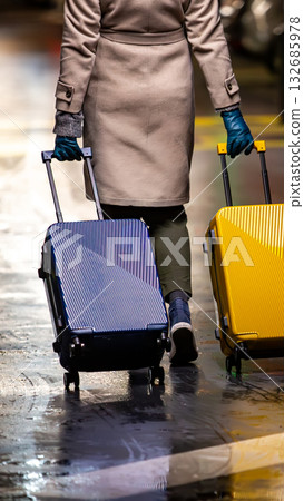 A chic traveler with two suitcases. A chic traveler with two suitcases. 132685978