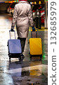 A chic traveler with two suitcases. 132685979