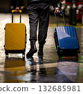 A traveler with colorful luggage. 132685981