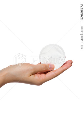 Hand presenting clean, white cosmetic cotton pad isolated on transparent background. Represents skincare, makeup removal, facial routine, personal hygiene concepts Hand presenting clean, white cosmetic cotton pad isolated on transparent background. Represents skincare, makeup removal, facial routine, personal hygiene concepts 132686378