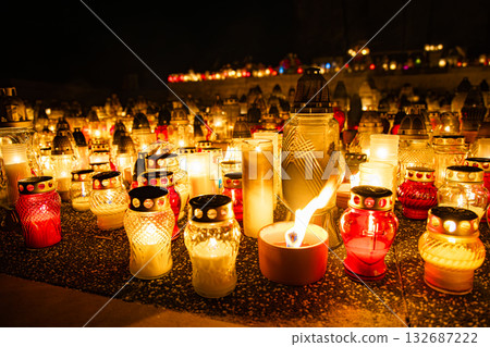 All Saints Day candles and lanterns glowing at night, cemetery memorial background in Poland 132687222