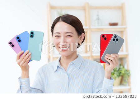 A woman with multiple smartphones A woman with multiple smartphones 132687823