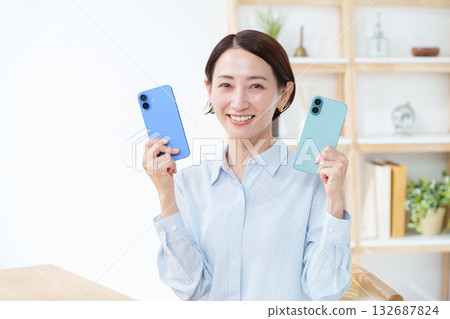 A woman with multiple smartphones A woman with multiple smartphones 132687824