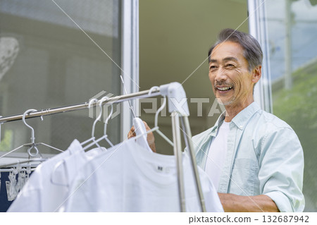 Senior man drying laundry 132687942