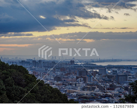 Dawn in the city: A view of the Osaka skyline across Osaka Bay from a hill in Kobe Dawn in the city: A view of the Osaka skyline across Osaka Bay from a hill in Kobe 132687989