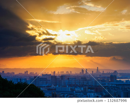 Dawn in the city: A view of the Osaka skyline across Osaka Bay from a hill in Kobe Dawn in the city: A view of the Osaka skyline across Osaka Bay from a hill in Kobe 132687996