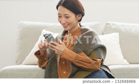 Woman operating a mobile phone Woman operating a mobile phone 132688866