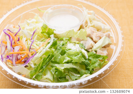 Delicious raw vegetable chicken salad in a plastic cup with dressing Delicious raw vegetable chicken salad in a plastic cup with dressing 132689074