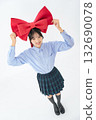 Teenage woman holding a large ribbon 132690078