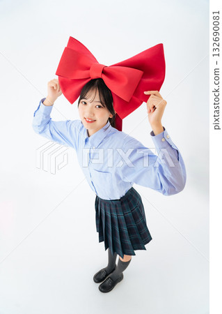 Teenage woman holding a large ribbon Teenage woman holding a large ribbon 132690081