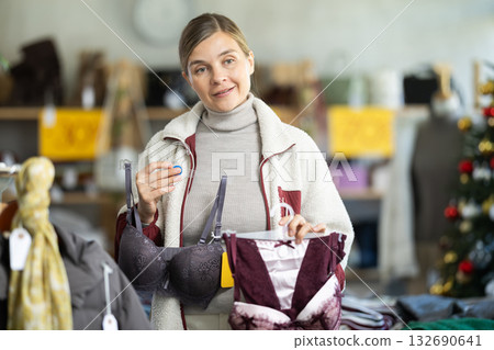 Adult woman chooses underwear in clothing store Adult woman chooses underwear in clothing store 132690641
