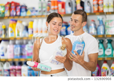 Married couple chooses cleaning product in supermarket Married couple chooses cleaning product in supermarket 132690908