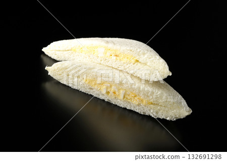 Egg sandwich photographed against a black background 132691298