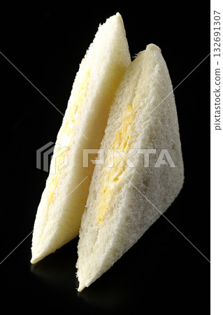 Egg sandwich photographed against a black background 132691307