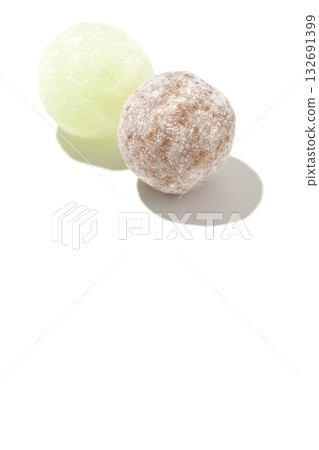 白色背景上的可樂味與哈密瓜味糖果照片 132691399