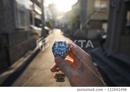 Wristwatch held up on urban street Wristwatch held up on urban street 132691496