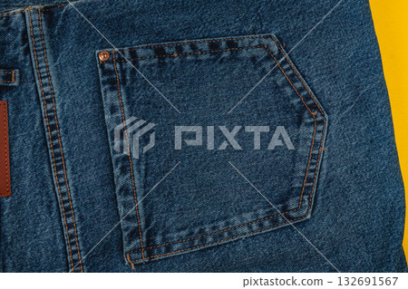 Denim fabric with detailed stitching and pocket design on bright background Denim fabric with detailed stitching and pocket design on bright background 132691567