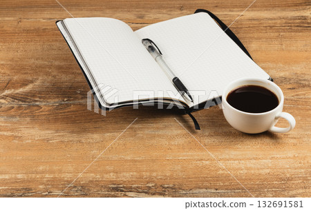 Notes and coffee on a wooden table in a quiet workspace 132691581