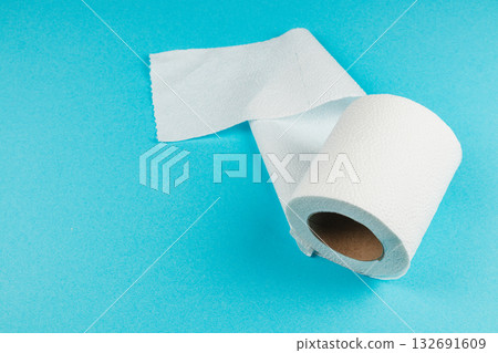 Roll of white kitchen paper towel on blue background ready for use Roll of white kitchen paper towel on blue background ready for use 132691609