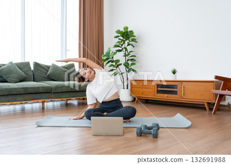 Young Asian woman stretching yoga workout on exercise mat Young Asian woman stretching yoga workout on exercise mat 132691988