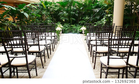 Long white carpet leads to a row of black chairs 132692368